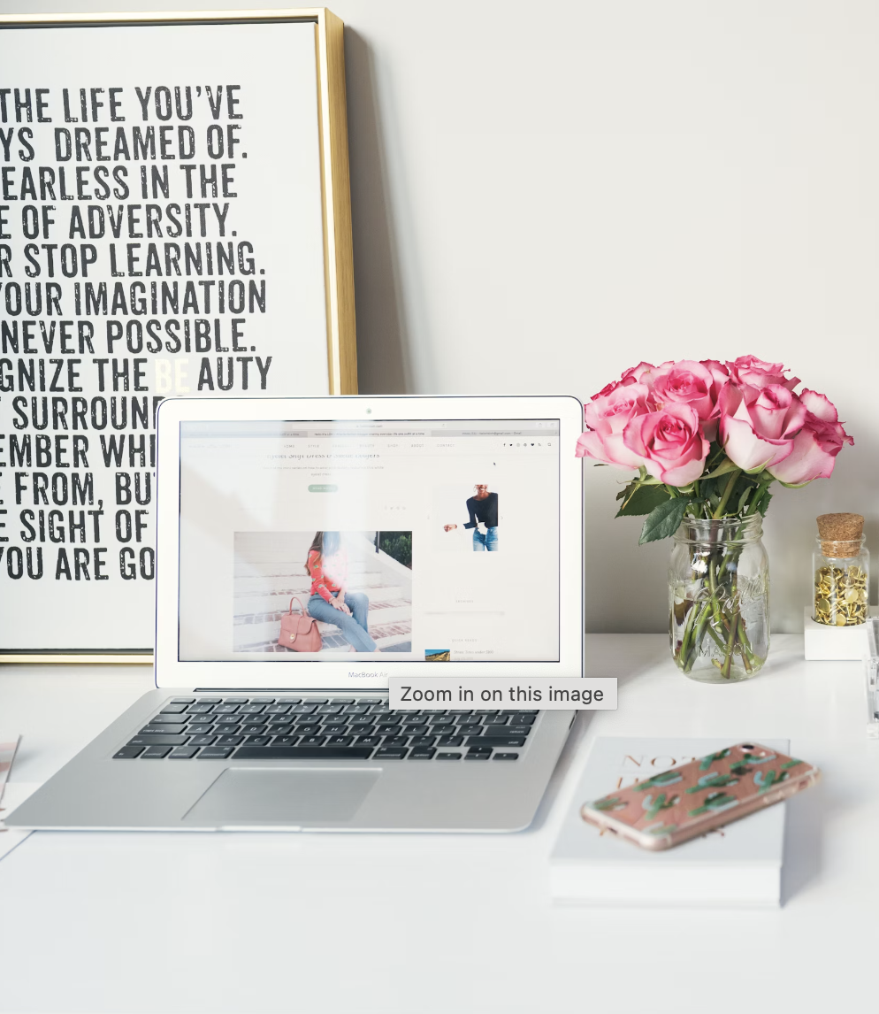 Picture of a laptop, flowers, and desk for a Digital Marketing Audit